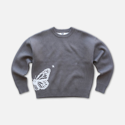 Front view of butterfly knit sweater on white background